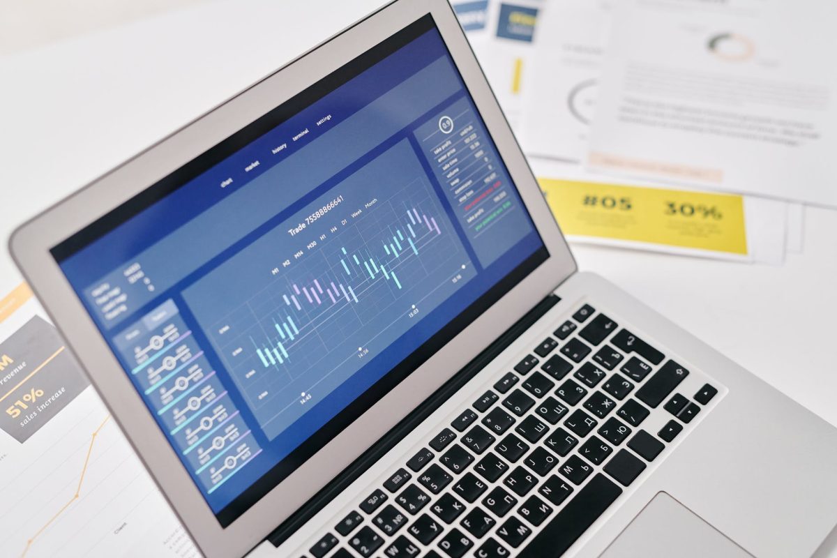 a laptop beside the documents